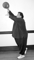 photo of large man throwing a basketball